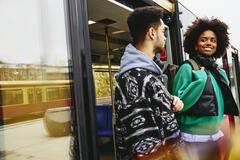 Man and woman getting out of a bus.