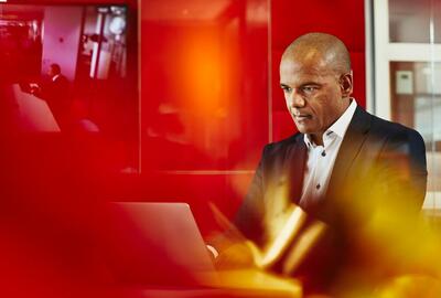 a man is using his laptop in the meeting room