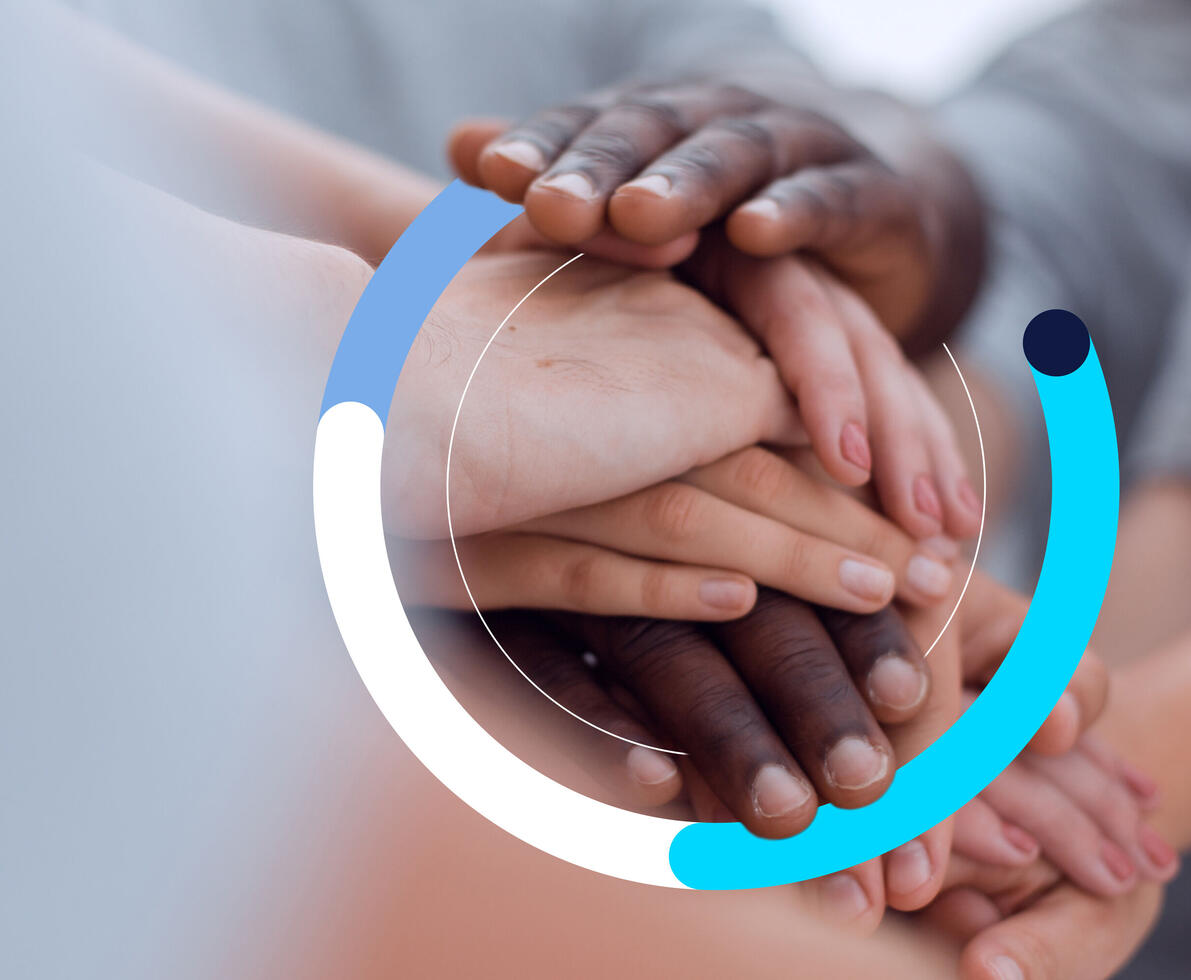 hands of different colours on top of each other