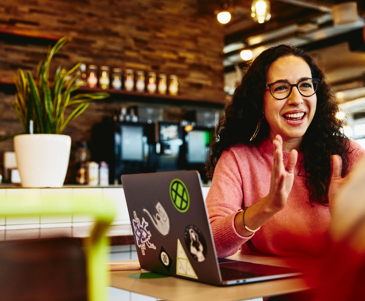 woman happily clapping hands in front of her colleagues