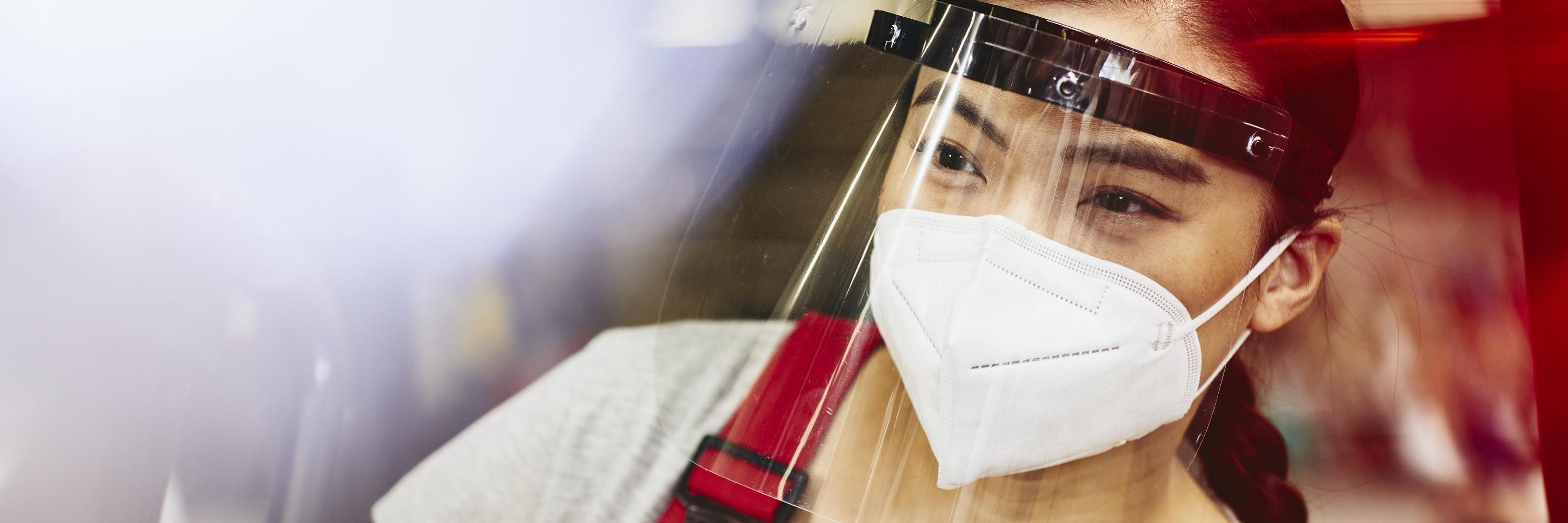 woman wearing mask and face shield at work.