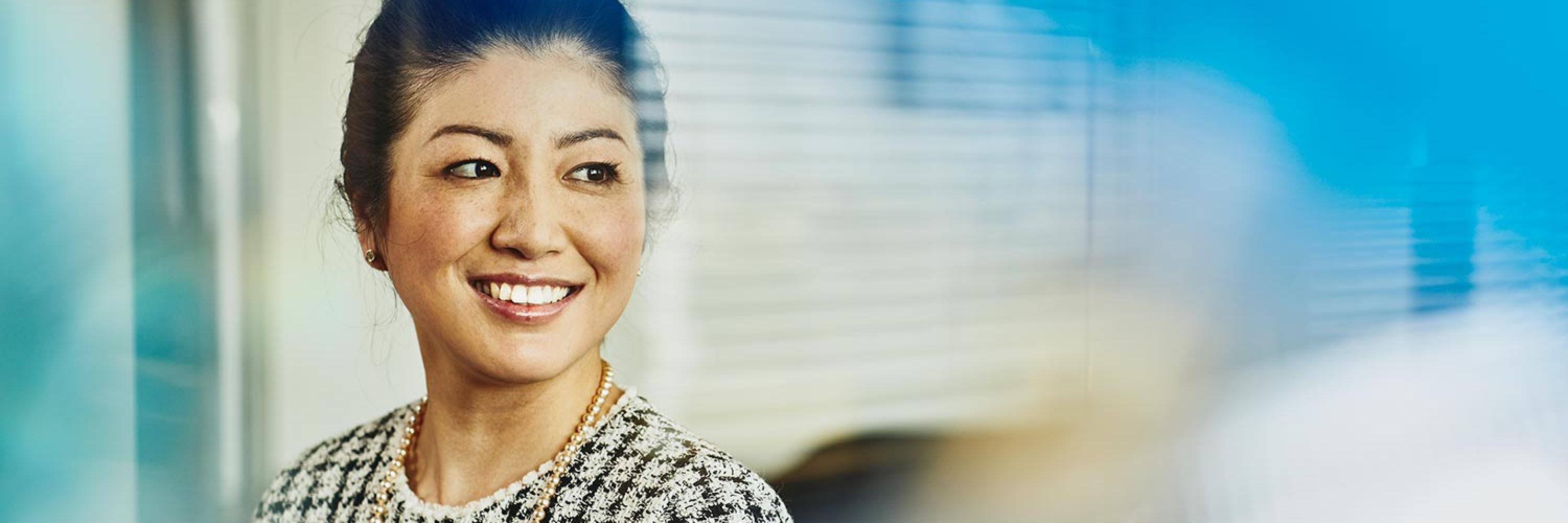 woman in corporate outfit smiling