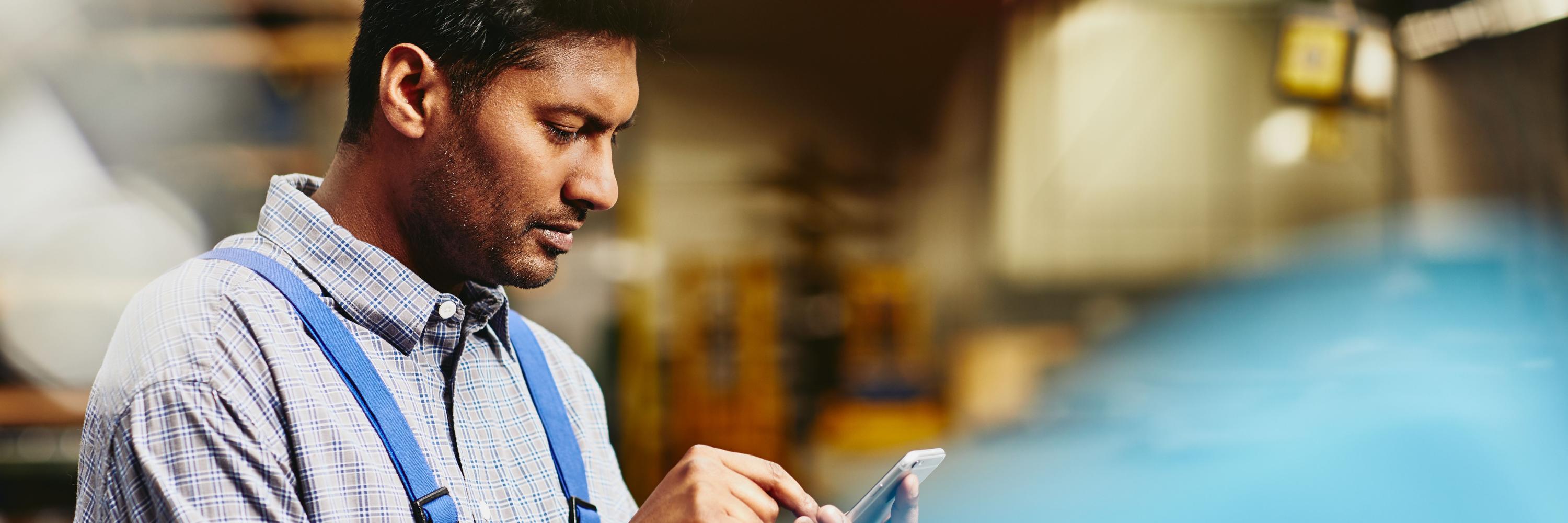 man looking at tablet