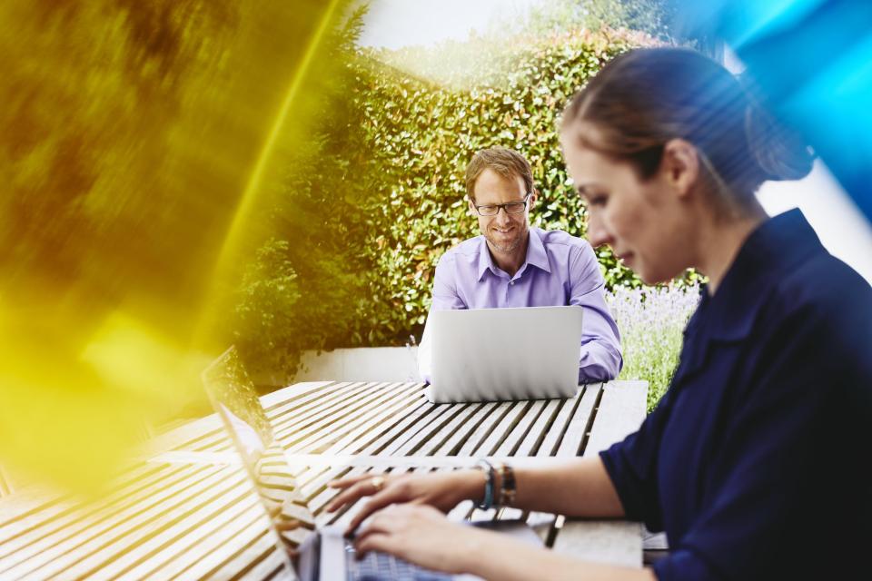 two people looking at laptops